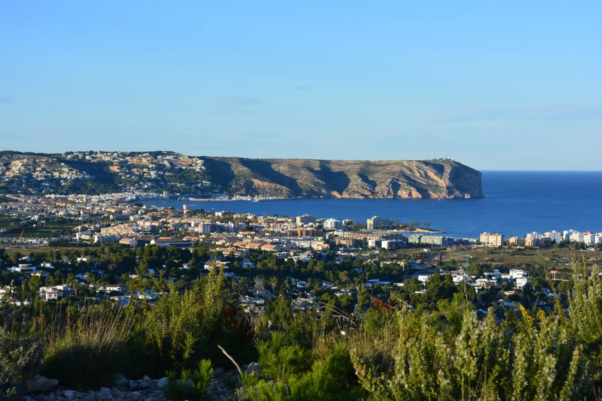 Panoramic view of Arenal Beach and the bay of Javea, Costa Blanca, Spain, showing the sandy beach, town, and Cabo de San Antonio headland.