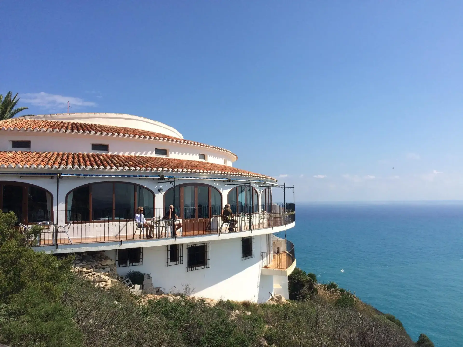 Restaurant El Mirador building perched on a cliff overlooking the Mediterranean Sea